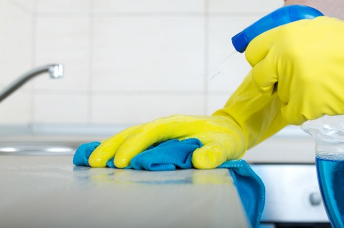 Technician inspecting a carpet before cleaning under service terms