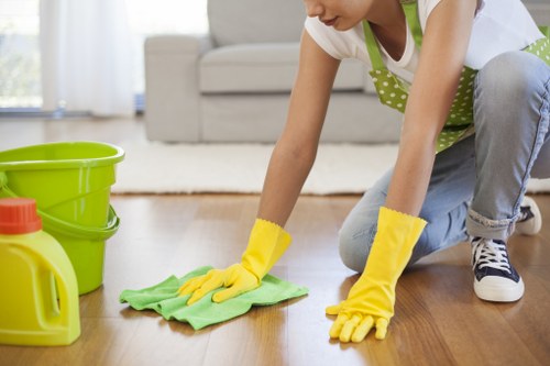 Post-build cleaning service polishing windows and fixtures in a Brent apartment